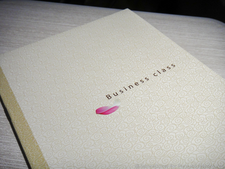 a white paper with a pink flower on it