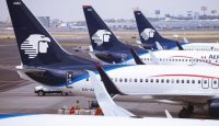 several airplanes parked at an airport