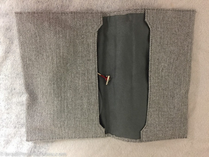 a pocketbook with a red and black handle