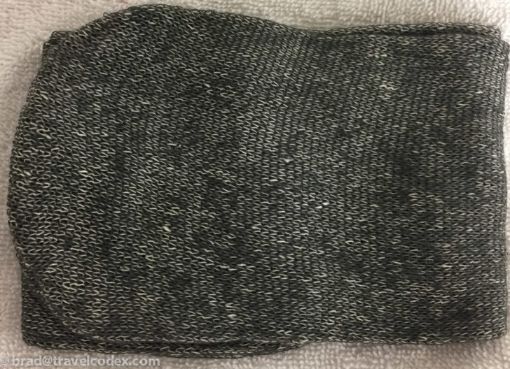 a grey and white knitted mitten