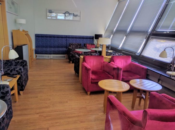 a room with a couch and chairs