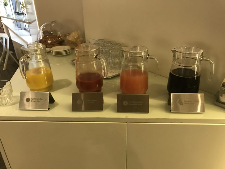 a group of glasses with different colored liquid