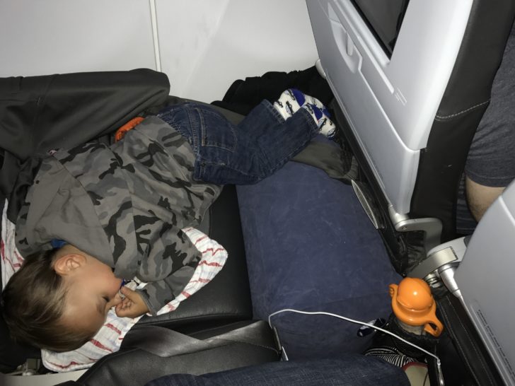 a baby sleeping on a seat
