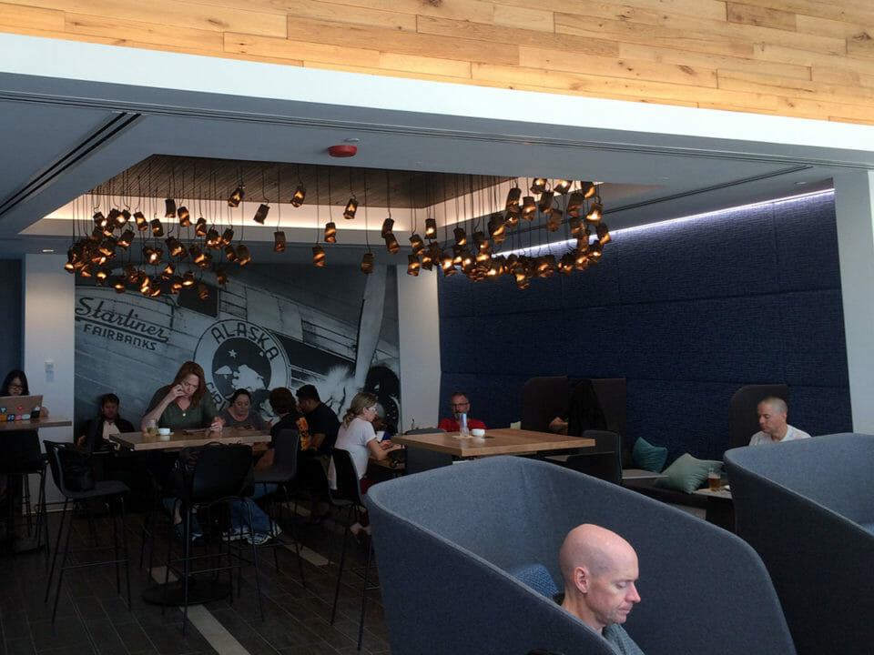 a group of people sitting at tables in a restaurant