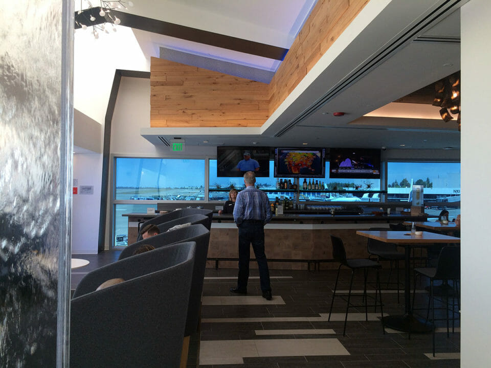 a man standing in a room with a bar
