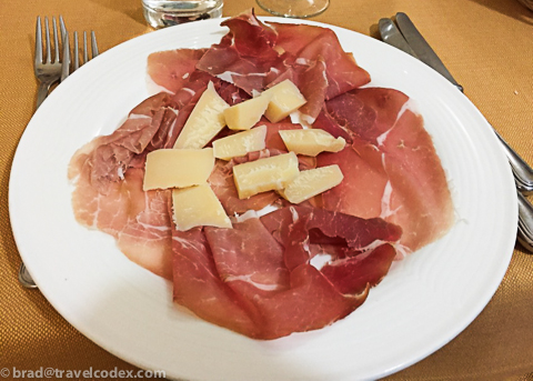 a plate of meat and cheese