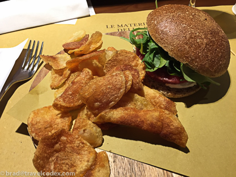 a burger and chips on a table