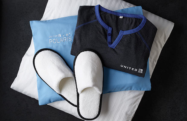 a pair of slippers and a shirt on a pillow