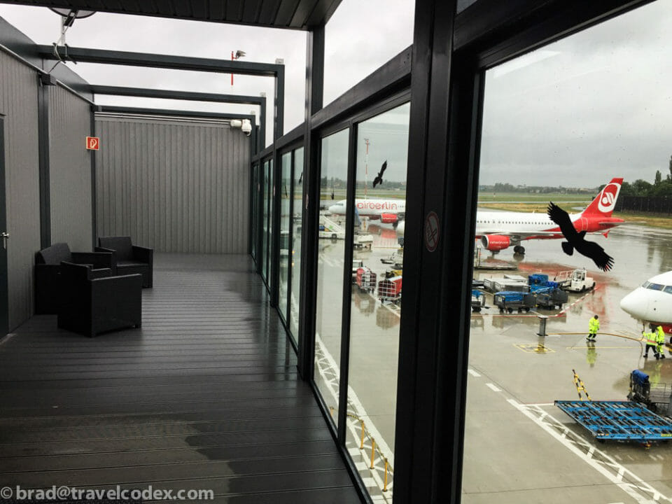 a room with windows and a plane in the background