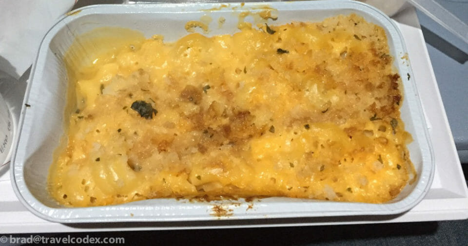 a white tray with food in it