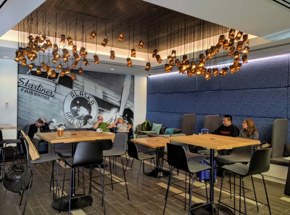 a group of people sitting at tables in a room with blue walls
