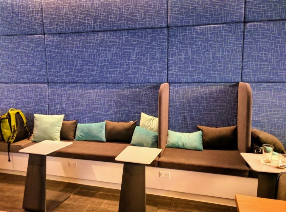 a couch with pillows and tables in a room
