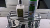 a metal tray with bottles and a bottle of spray on top