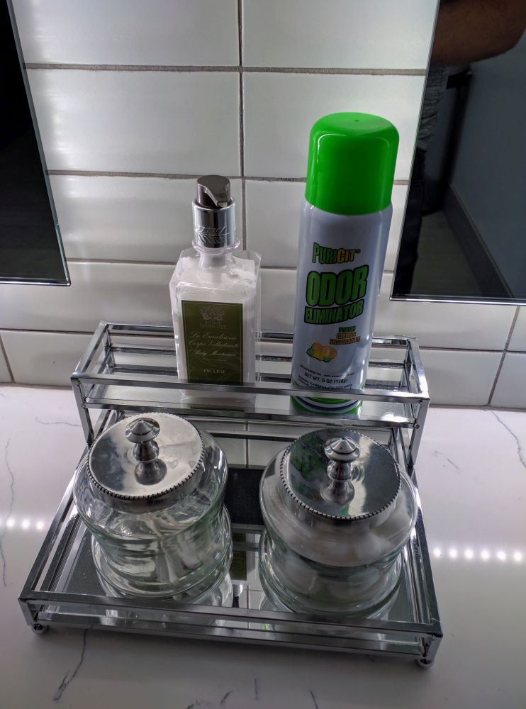 a metal tray with bottles and a bottle of spray on top