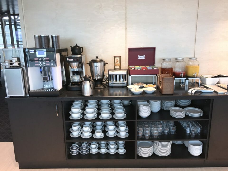 a black shelf with white plates and cups on it