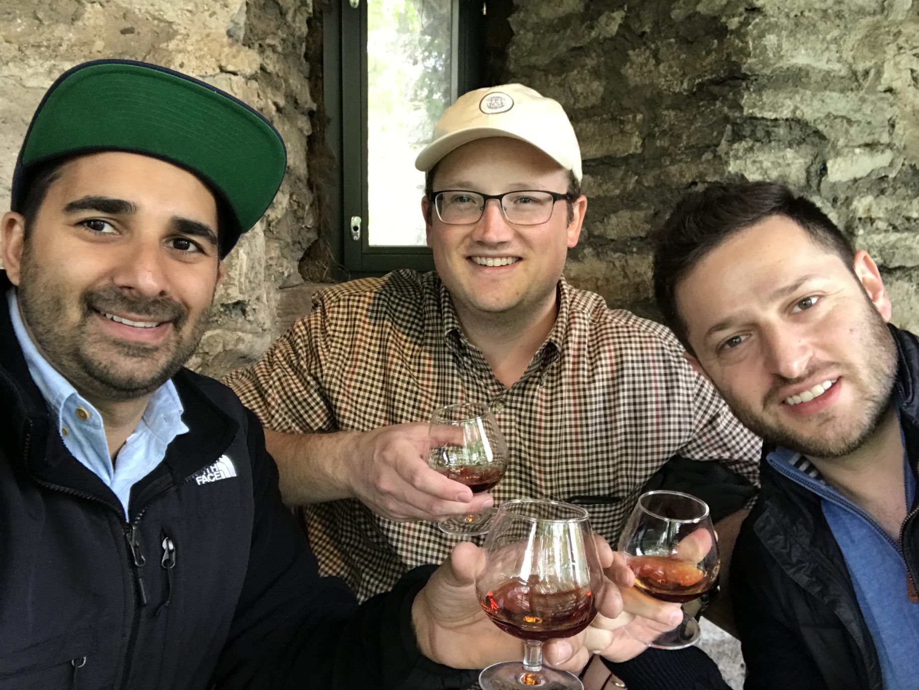a group of men holding wine glasses