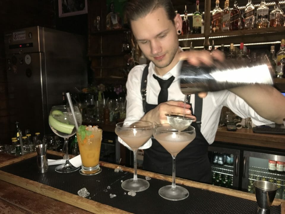 a man pouring a drink into a glass
