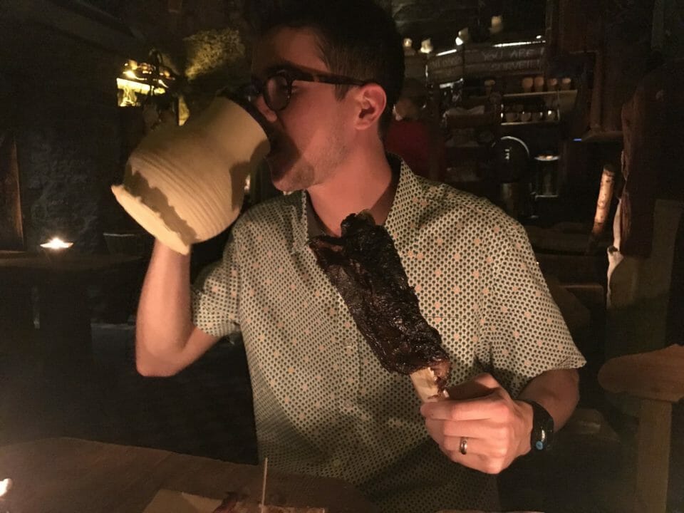 a man drinking from a large jug