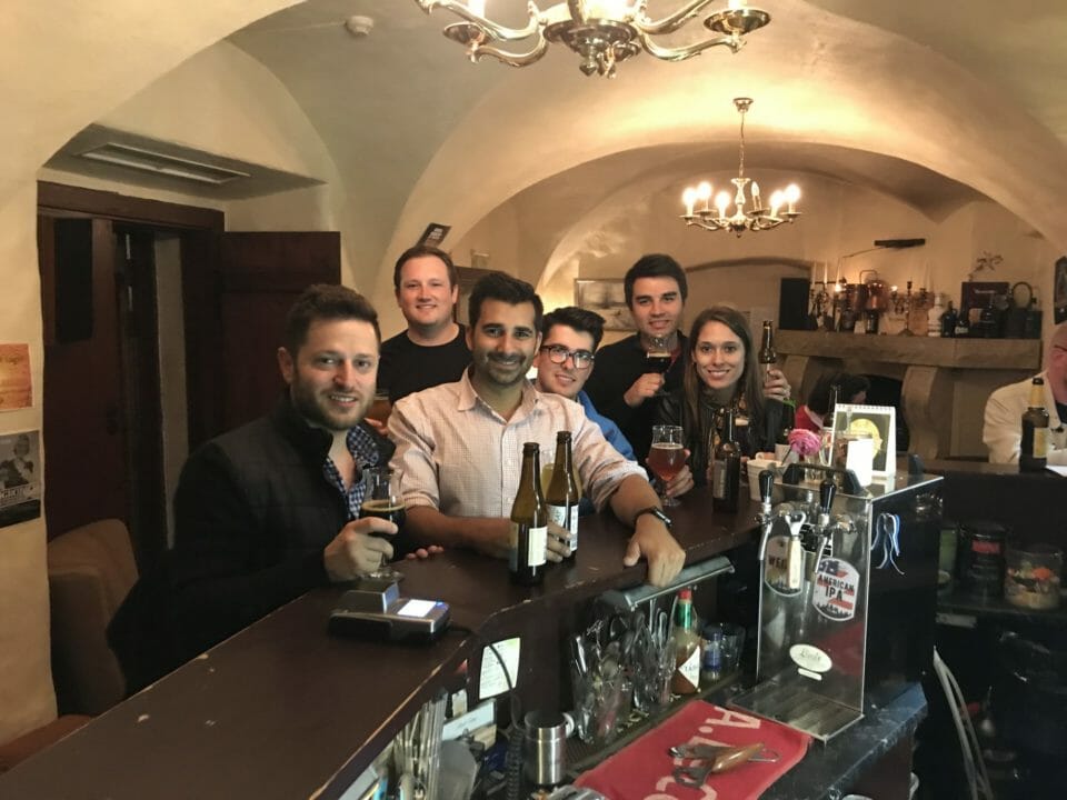 a group of people standing at a bar