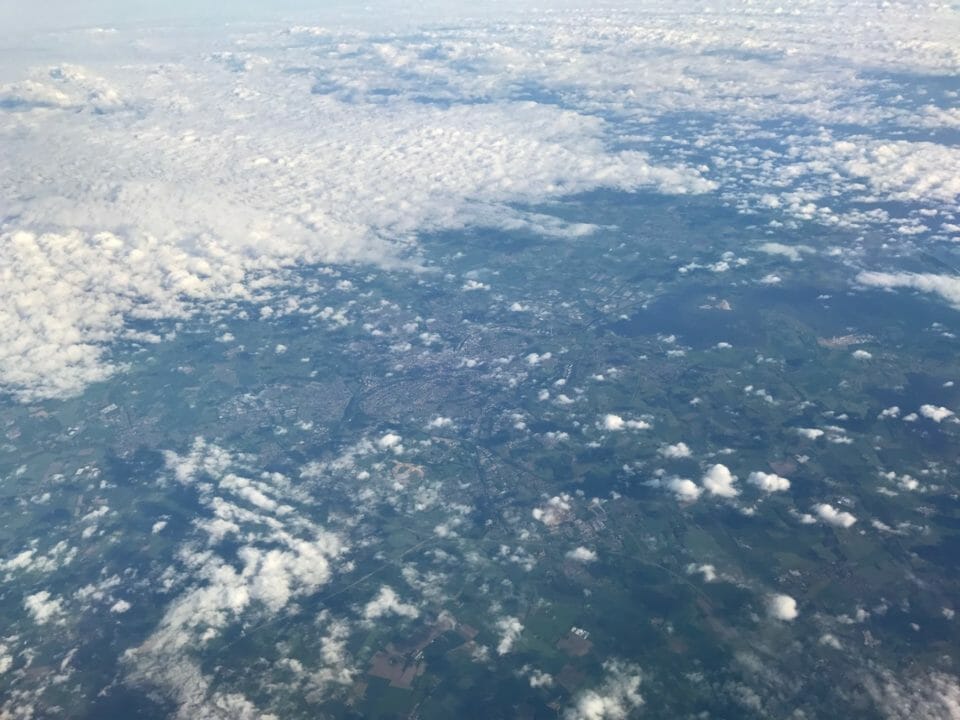 aerial view of clouds and land from an airplane