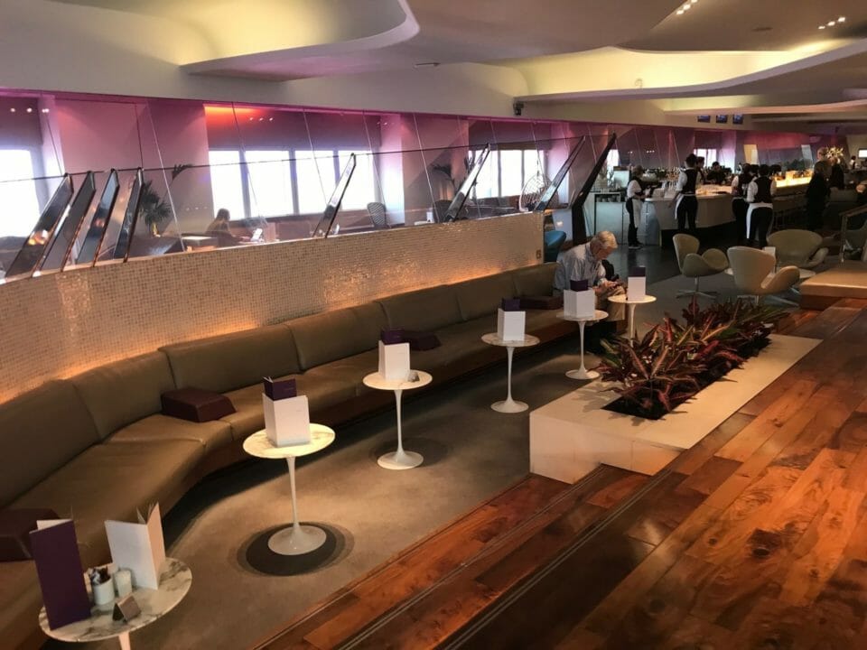 a room with a long couch and tables