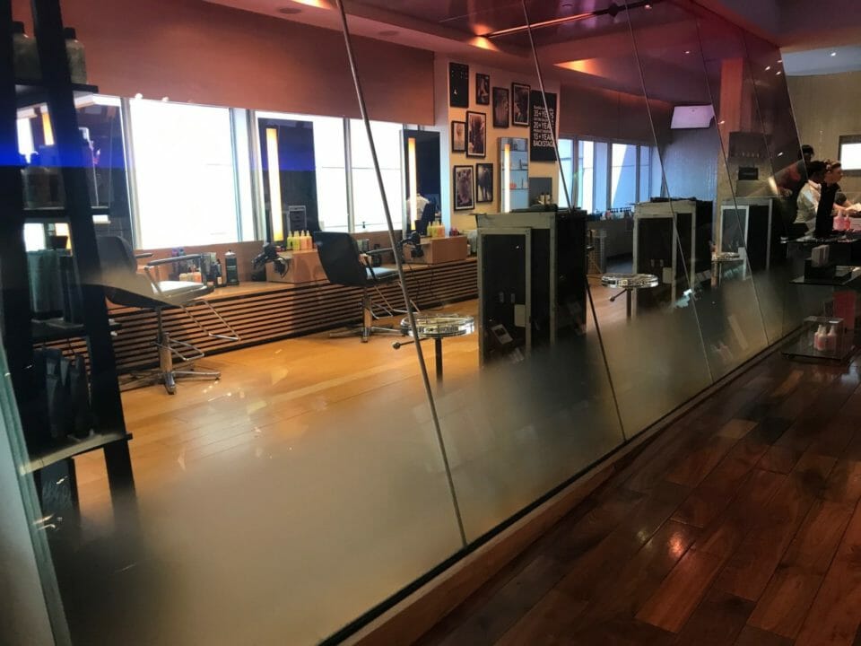 a room with a mirror and chairs