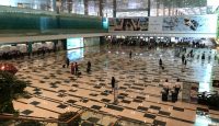 a large hall with people walking and people walking