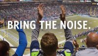 a group of people raising their hands in a stadium