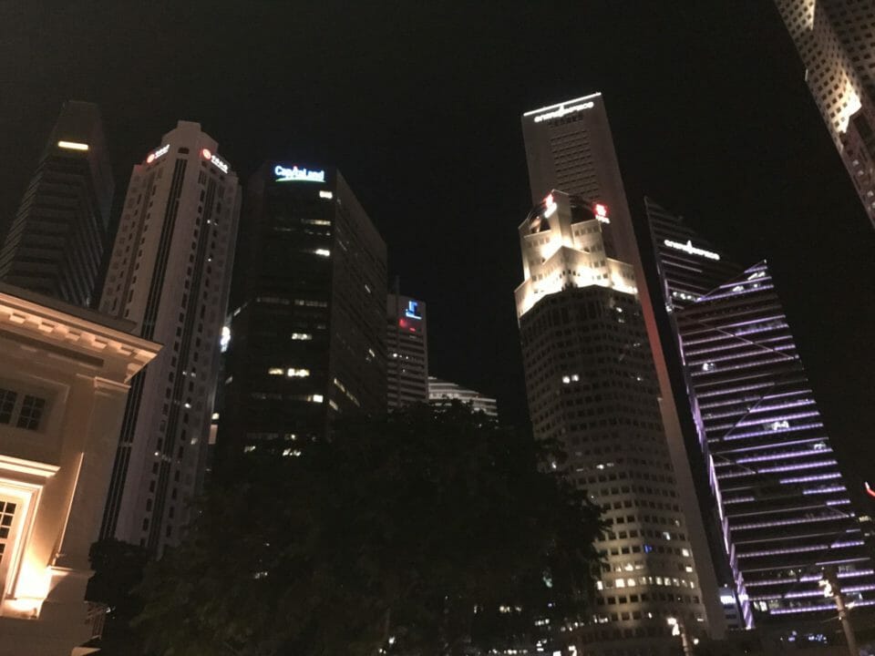 a group of tall buildings at night