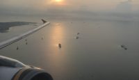 an airplane wing and engine above water