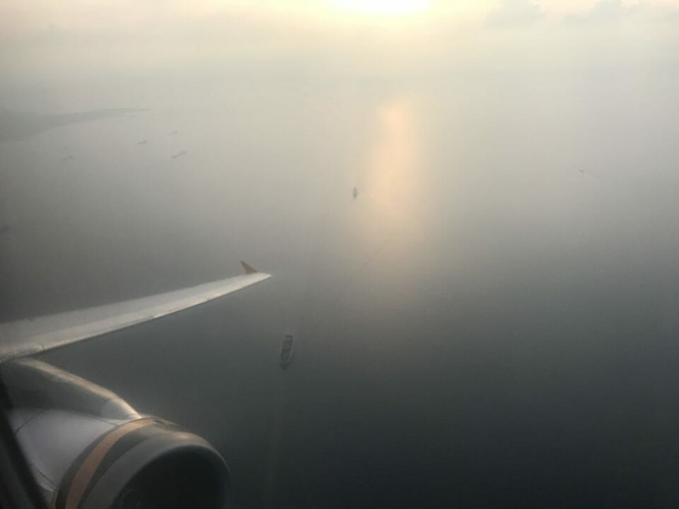 an airplane wing and a body of water