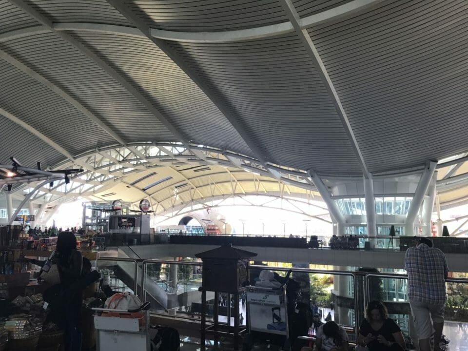 a large white building with glass walls and a large white ceiling
