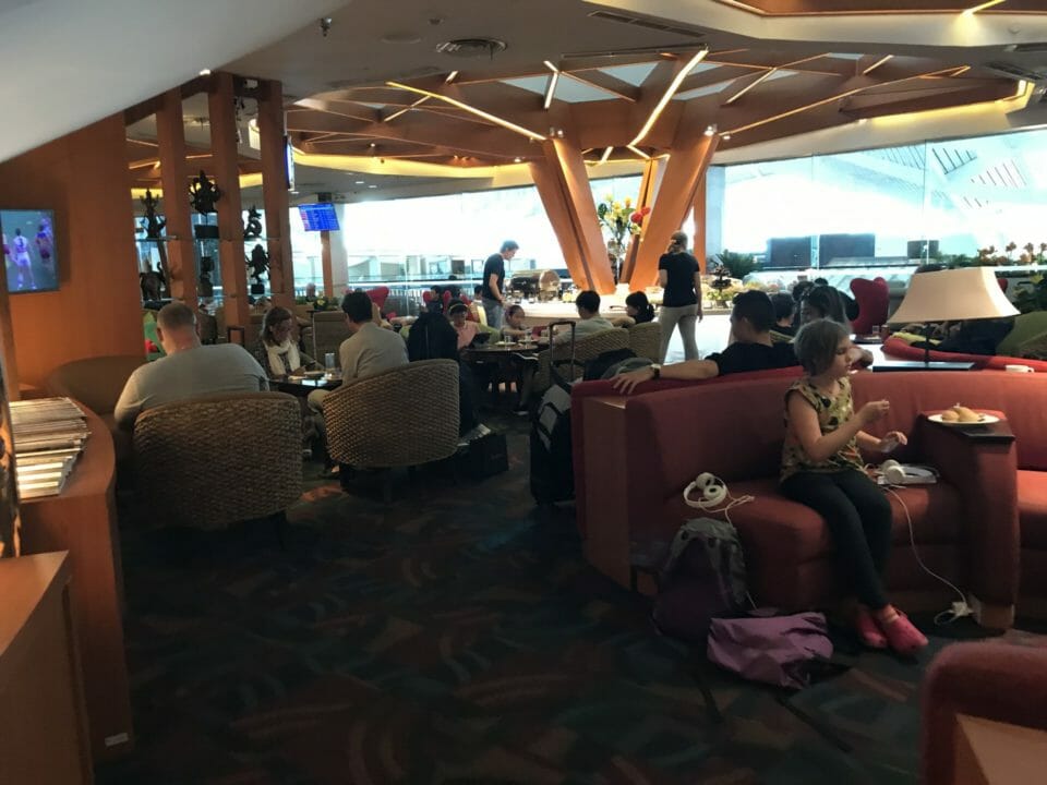 a group of people sitting on couches in a room with a large window