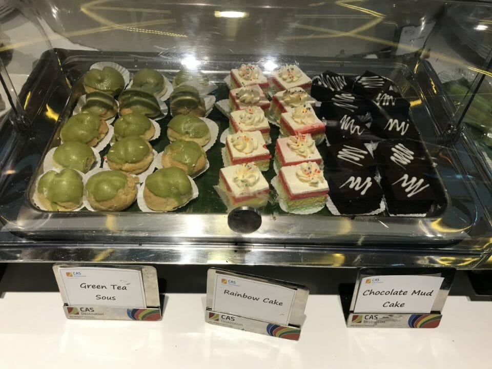 a display case of cakes and desserts