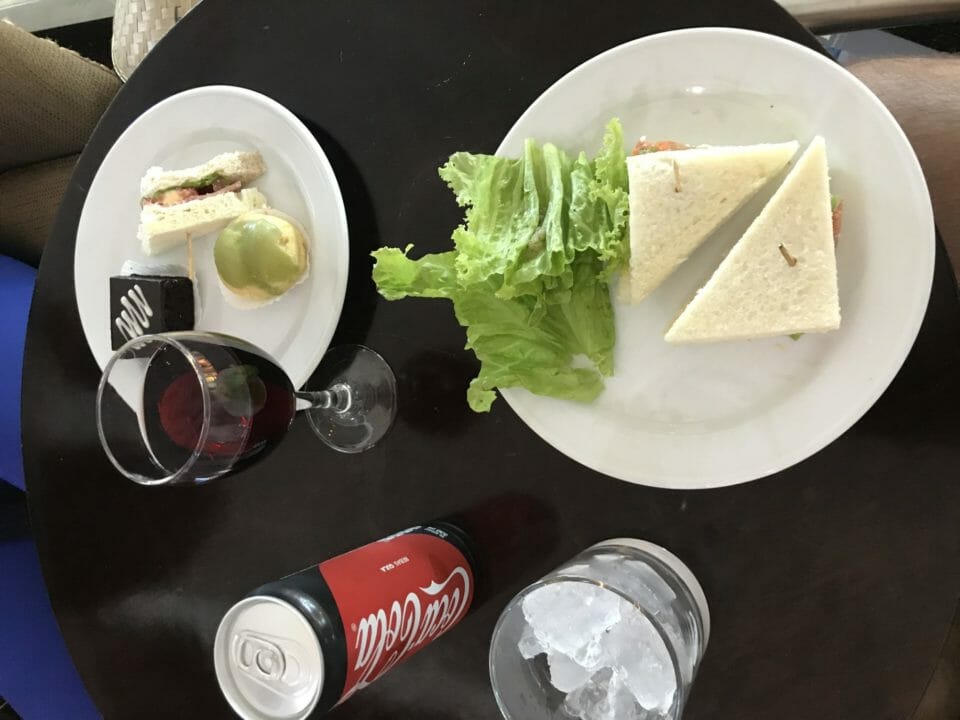 a plate of sandwiches and a drink on a table