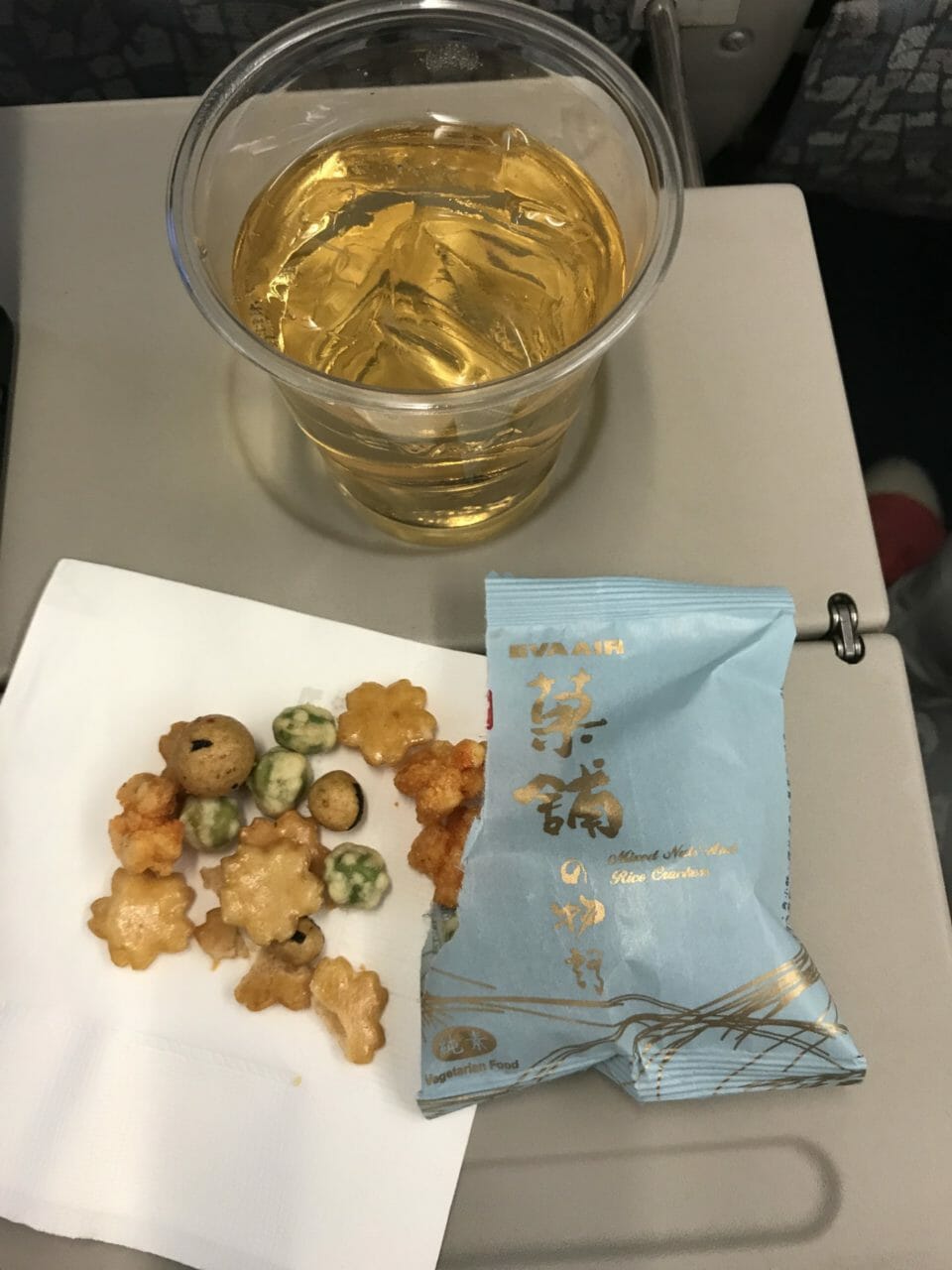 a glass of liquid and food on a table