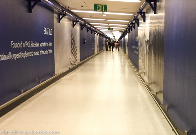 a long hallway with people walking on it