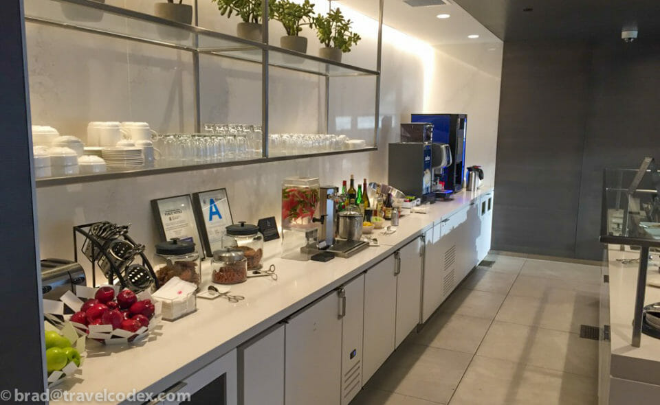 a kitchen with white cabinets and shelves