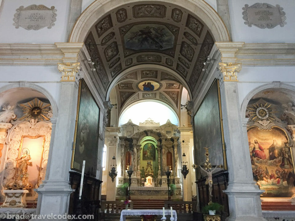 a church with a large ceiling and a painting