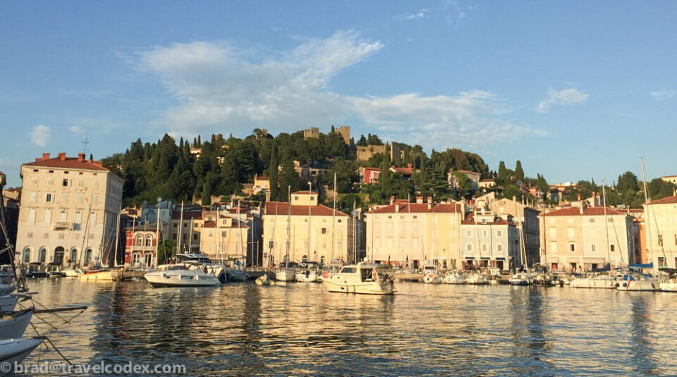 a body of water with boats and buildings on the side