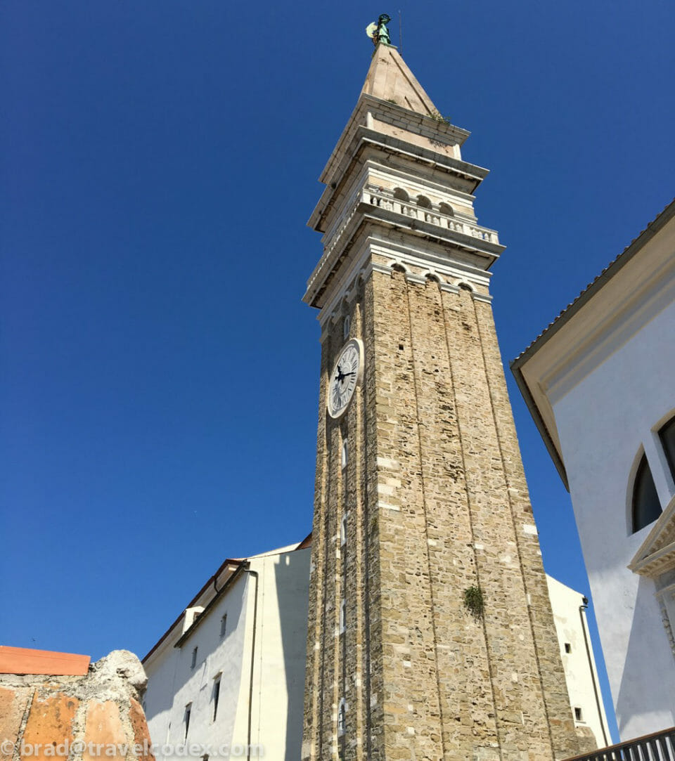 a tall stone tower with a clock on it