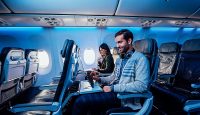 a man and woman sitting in an airplane