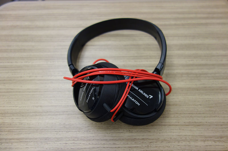 a pair of black headphones with red wire