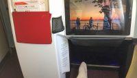a person's feet in a chair with a tv on the back