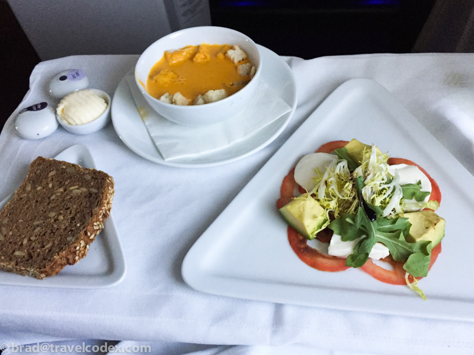 a plate of food and a bowl of soup on a table