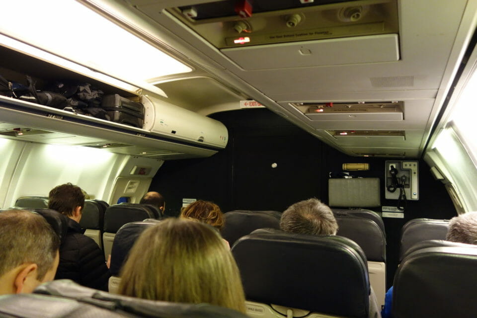 a group of people sitting in an airplane