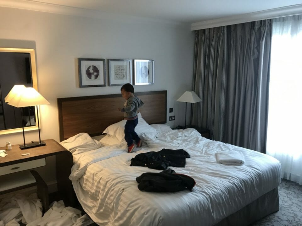 a boy jumping on a bed