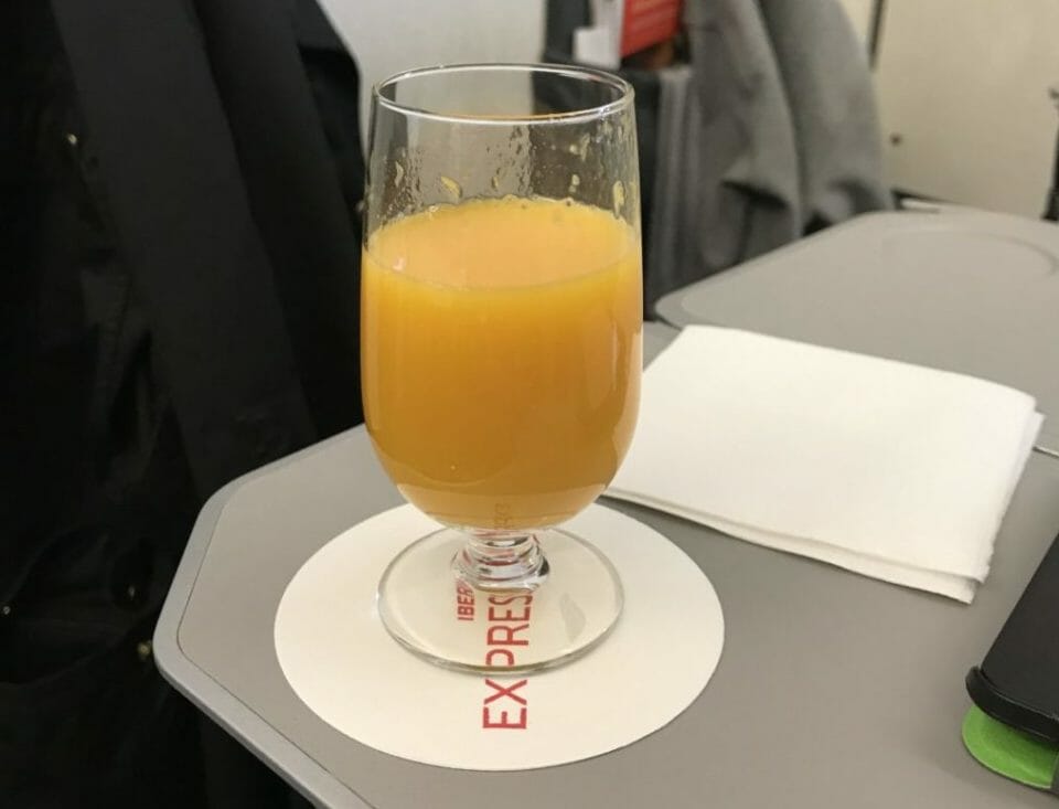 a glass of orange juice on a table