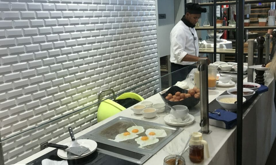a man cooking eggs in a kitchen