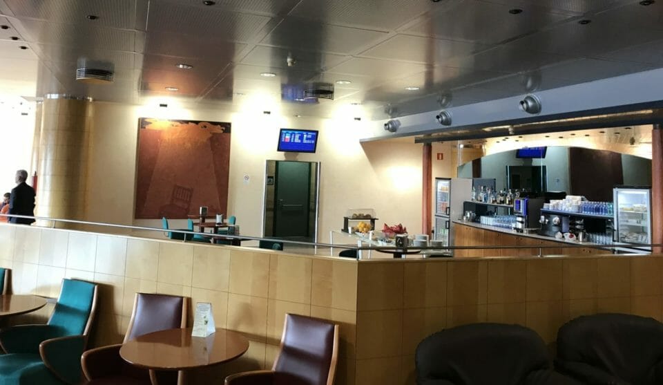 a room with a counter and chairs